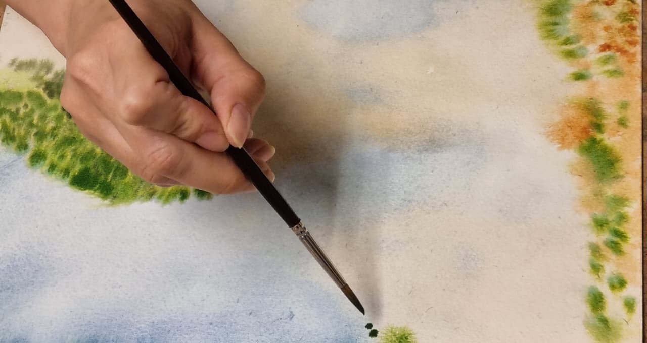 Pincelada de acuarela sobre un paisaje en proceso
